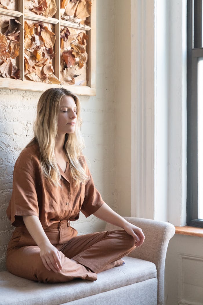 A Woman in Brown Clothes Sitting on the Couch
